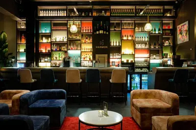 a bar with couches and a shelf of wine bottles at Harmon House - Hotel & Spa in Brussels