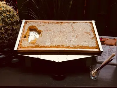 a container of honey sitting on top of a table at Harmon House - Hotel & Spa in Brussels