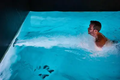a man is in a swimming pool at Harmon House - Hotel & Spa in Brussels