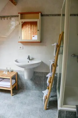 a bathroom with a sink and a toilet and a shower at De Loteling in Zoersel
