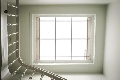 a window in a white room with a staircase at 22b&b in Antwerp