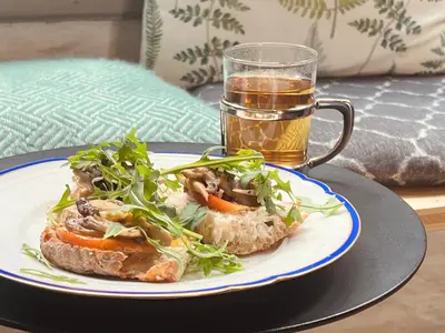 a sandwich on a plate with a glass of beer at 22b&b in Antwerp