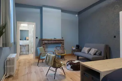 a living room with a couch and a fireplace at 22b&b in Antwerp