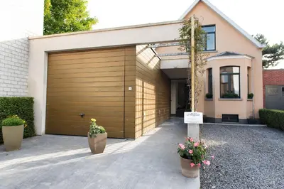 a garage door with two potted plants in front of it at B&B Alegría in Mechelen