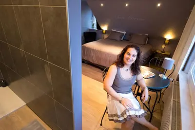 a woman is standing in a hotel room at B&B Alegría in Mechelen