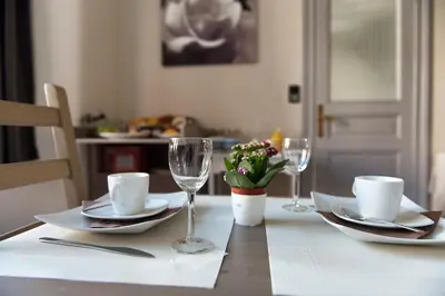 a table with plates and wine glasses on it at B&B Alegría in Mechelen