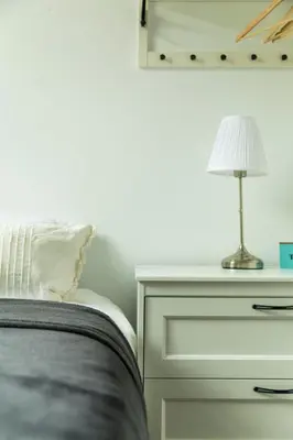 a bedroom with a bed and a lamp on a dresser at B&B Daya in Kessel-Lo