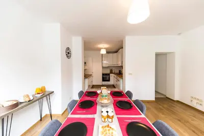 a dining room with a red table and chairs at B&B Daya in Kessel-Lo