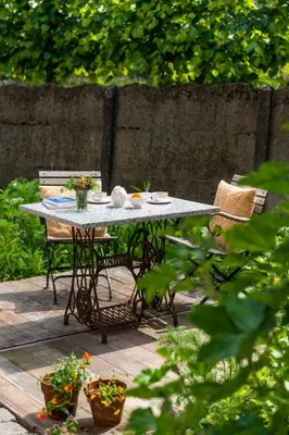 a table and chairs on a patio in a garden at B&B Art.14 in Morkhoven