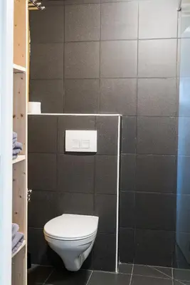 a bathroom with a white toilet in a room at B&B Art.14 in Morkhoven