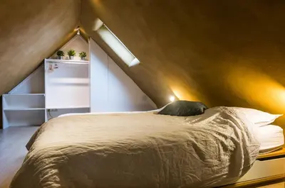 a bedroom with a large bed in a attic at B&B Art.14 in Morkhoven