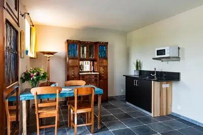 a kitchen and dining room with a table and chairs at B&B Art.14 in Morkhoven