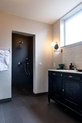 a bathroom with a black sink and a shower at B&B Art.14 in Morkhoven