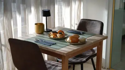 a wooden table with a plate of food on it at Hotel Lepelbed in Ghent