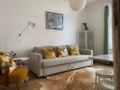 a living room with a couch and a table at Rétro Studio in Brussels
