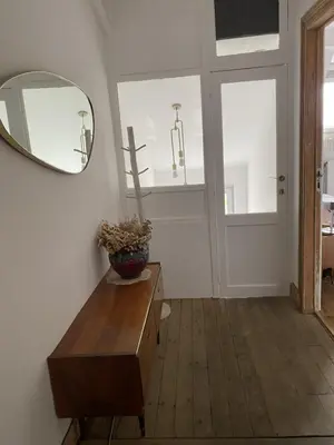 a room with a mirror and a wooden table at Rétro Studio in Brussels