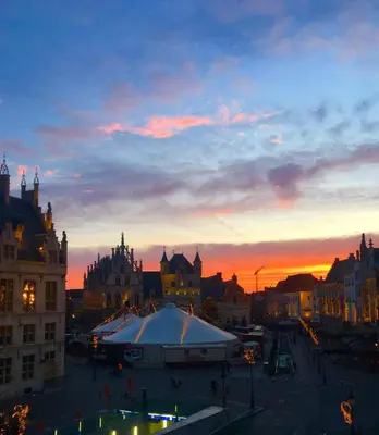a view of a city at sunset at Margaretha's Room in Mechelen