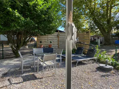 a group of chairs and a table in a yard at Vakantiehuisje De Waterhoek in Geel