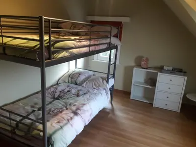 a bunk bed room with two bunk beds and a desk at Prachtig herenhuis uit 1925 in Nijlen