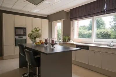 a kitchen with a table with glasses of wine at Prachtig herenhuis uit 1925 in Nijlen