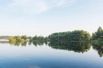 a large body of water with trees in the background at Hotel Kempense Meren by Sunparks in Mol