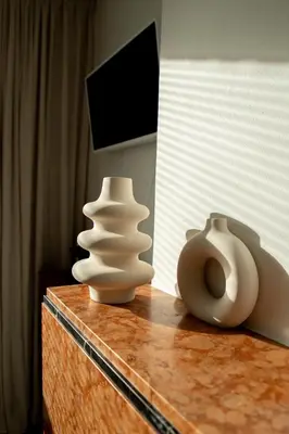 two white vases sitting on top of a table at huisalfons in Mechelen
