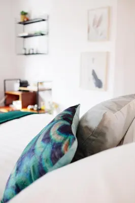 two pillows sitting on a bed in a room at huisalfons in Mechelen