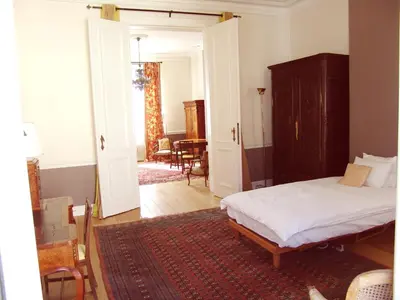 a bedroom with a bed and a dining room at Louise Chatelain suites in Brussels