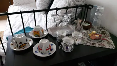 a black table with dishes and glasses on a bed at Harmony House in Antwerp