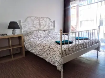 a bedroom with a white bed and a window at Harmony House in Antwerp