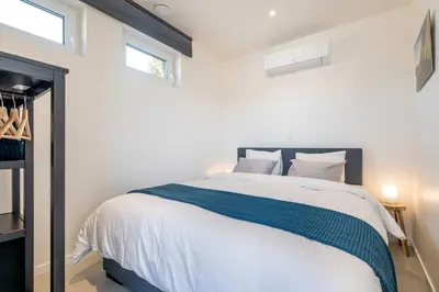 a bedroom with a bed with a blue and white blanket at Studio Brussels Airport - North in Zaventem