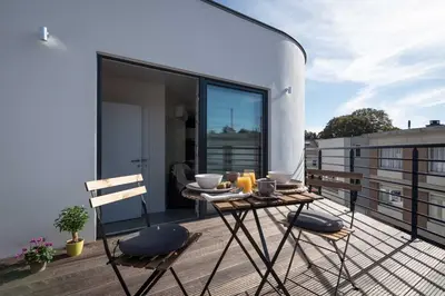a balcony with a table and chairs on a roof at Studio Brussels Airport - North in Zaventem