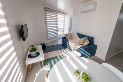 a living room with a table and chairs and a television at Studio Brussels Airport - North in Zaventem