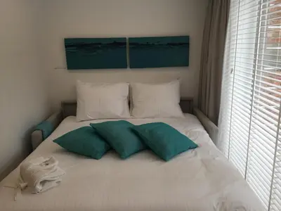 a bed with two pillows on it in a bedroom at Antwerp Town House Accommodations in Antwerp