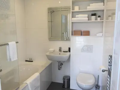a white bathroom with a sink and a toilet at Antwerp Town House Accommodations in Antwerp