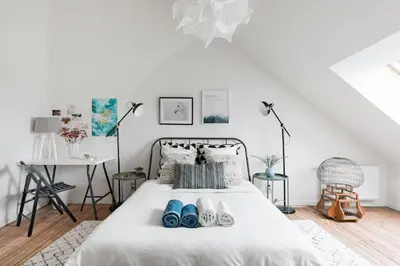 a bedroom with a white bed with shoes on it at Flemishome, The Retreat For Family And Friends in Halle