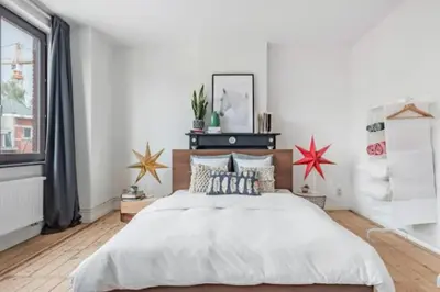 a bedroom with a large bed and a window at Flemishome, The Retreat For Family And Friends in Halle