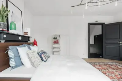 a bedroom with a large white bed with pillows at Flemishome, The Retreat For Family And Friends in Halle
