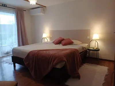 a bedroom with a bed with two red pillows on it at Guesthouse La maison de Fille in Diest