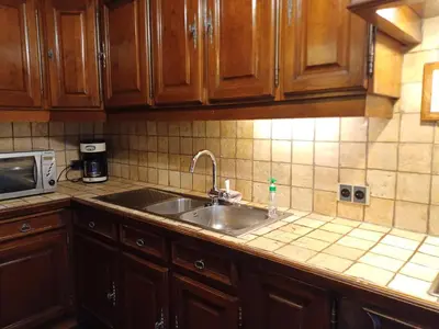 a kitchen with a sink and a microwave at Guesthouse La maison de Fille in Diest
