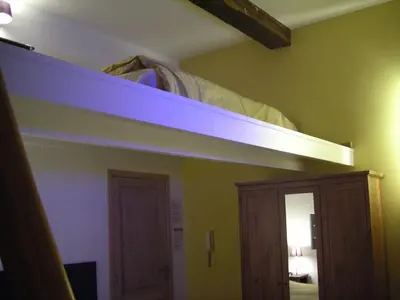 a bedroom with a bunk bed with a blue light on it at Huize Rafael in Leuven