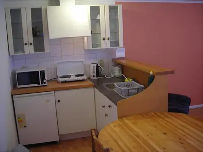 a small kitchen with a sink and a table at Huize Rafael in Leuven
