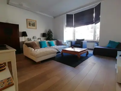 a living room with a couch and a coffee table at Brugmann Loft Apartment in Brussels