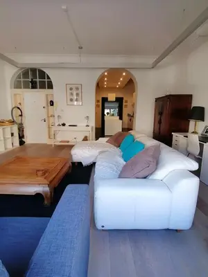 a living room with a white couch and a table at Brugmann Loft Apartment in Brussels