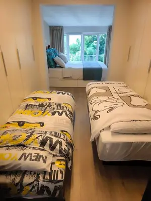a bedroom with two beds and a window at Brugmann Loft Apartment in Brussels