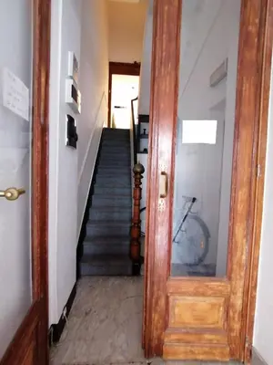 a hallway with a staircase and a wooden door at Brugmann Loft Apartment in Brussels