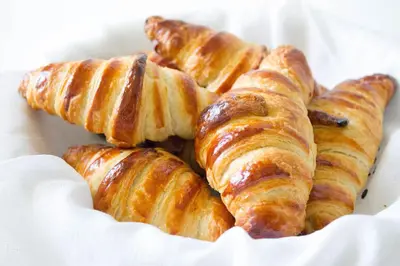 a pile of croissants in a white box at Hotel Malon in Leuven