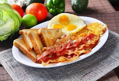 a plate of breakfast food with eggs and toast at Hotel Malon in Leuven