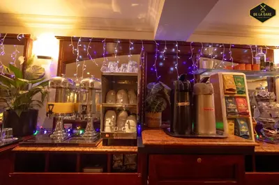 a bar with christmas lights on the wall and a counter at Hotel Malon in Leuven