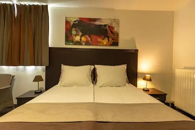 a bedroom with a large bed with two pillows at Hotel Malon in Leuven